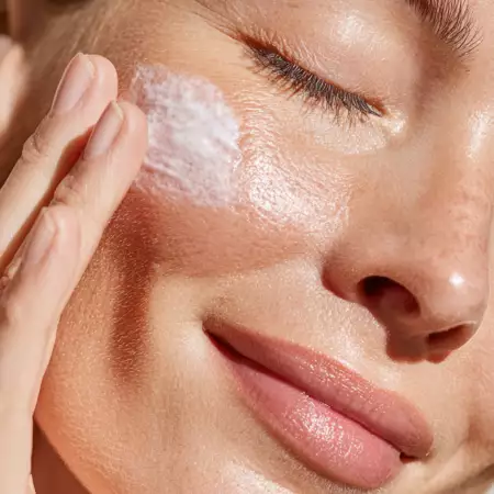 woman-applying-moisturizing-cream-face-beautiful-skin